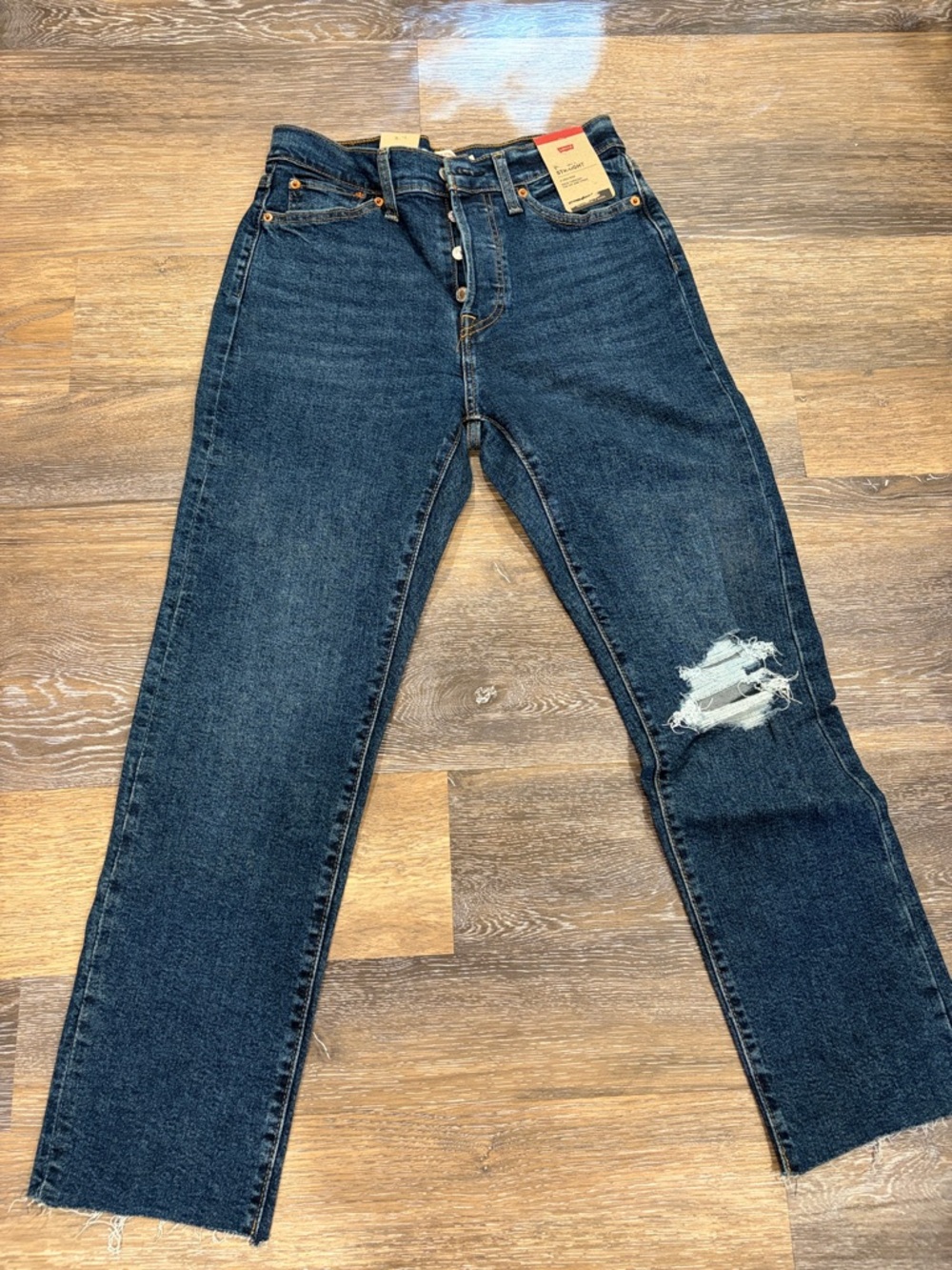 Levi's Dark Blue Straight Leg Jeans with Knee Rip.